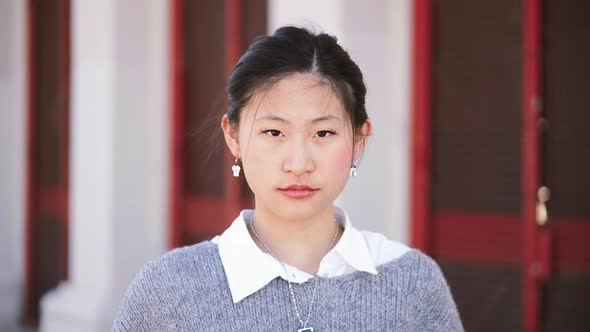 Portrait of Serious Asian Girl Looking at Camera