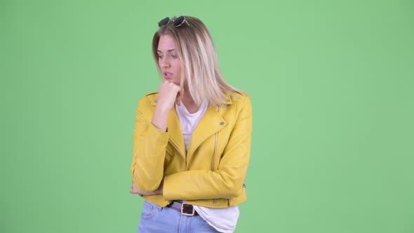 Stressed Young Rebellious Blonde Woman Thinking and Looking Down