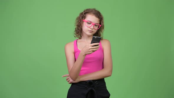 Young Happy Beautiful Nerd Woman Thinking While Using Phone