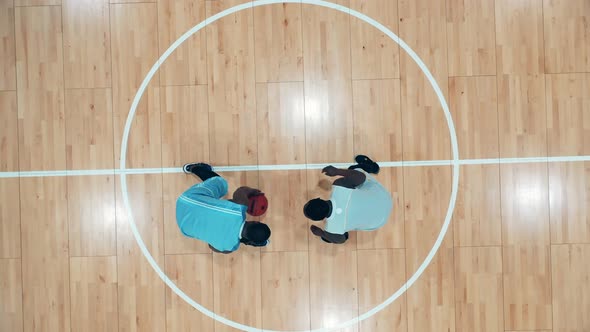 Two Basketball Players are Practicing in the Gym in a Top View