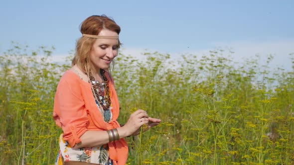 Portrait of Blonde Hippie Dancing in a Field with Flowers