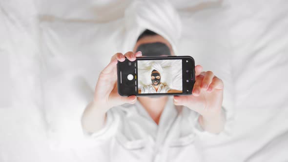 Female Portrait Holding Mobile Beauty Routine in Apartment