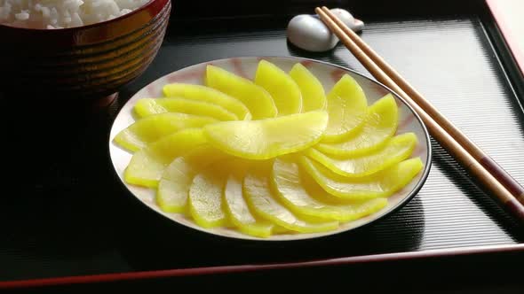 Japanese crunchy pickled daikon and slices close up as a side dish