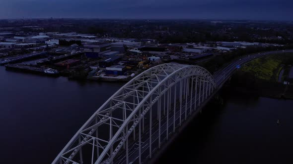 Steel Arch Bridge Over Noord River In South Holland, The Netherlands During Sunset. - Aerial Tilt Do