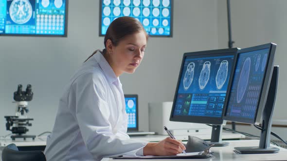 Professional medical doctor working in hospital office using computer technology.