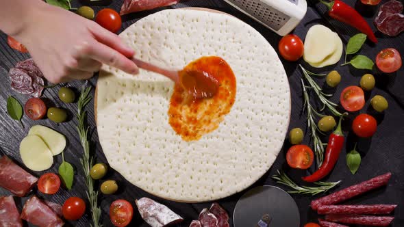 Top View of Making a Pizza with Ingredients Appearing on the Baking Plate