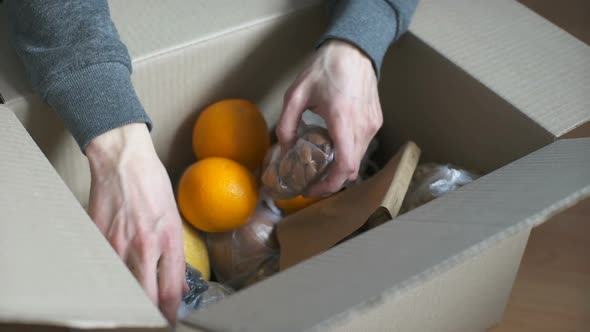 Man Examines Products Brought By Courier