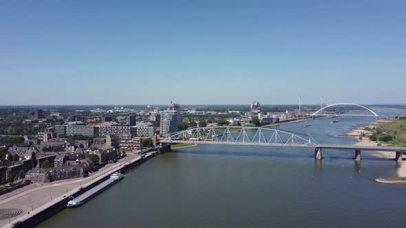 Railroad Bridge with yellow train over river Waal in Nijmegen, The Netherlands