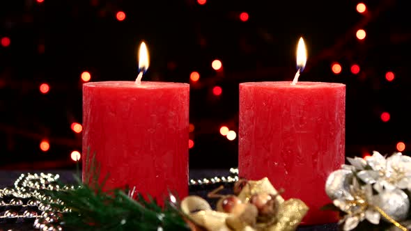 Two Red Candles with Christmas Decorations on Black, Bokeh, Light, Garland