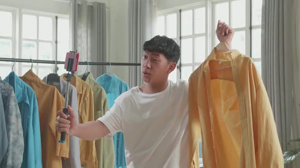 Asian Man Online Seller Recommending A Shirt And Recording Video By Mobile Phone While Selling