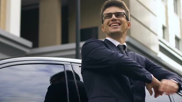 Confident Businessman Standing Near Car and Happily Smiling, Successful Deal