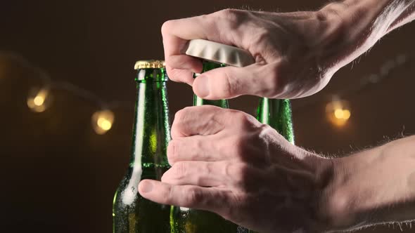 Man Opening Fresh Bottle of Beer and Taking It