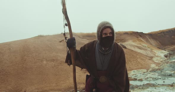 Hooded And Masked Man In Strange Landscape