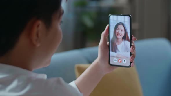 Close Up Of A Man Having Video Call With A Woman On Smartphone In The Living Room