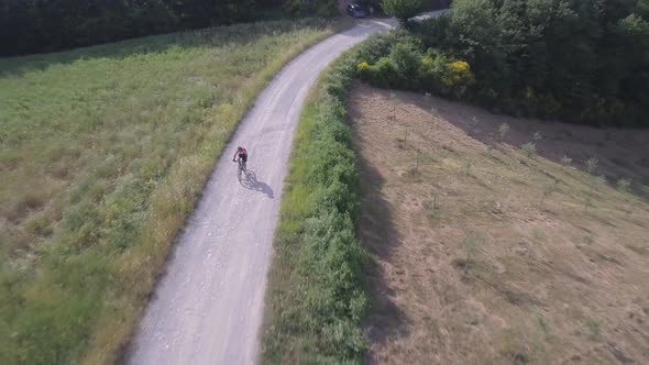 Man cycling with mountain bike on countryside road