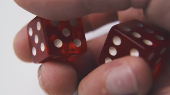 Young Person Shows Bright Dices Against Light Surface