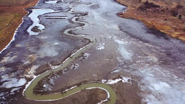 Natural problems of water. Dirty stream of dried lake. Gloomy background of environment. Global warm