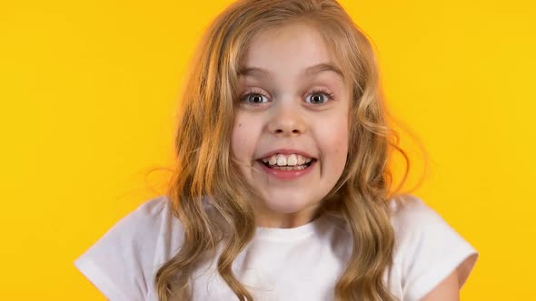 Surprised Girl Showing Yes Gesture Satisfied With Her Victory, Yellow Background