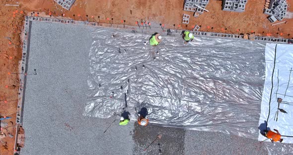 Installation of Barrier Plastic Before Pouring Concrete Construction
