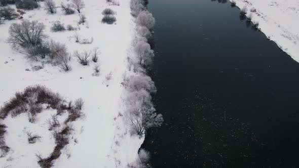 River in Winter Landscape with Shore Covered Snow