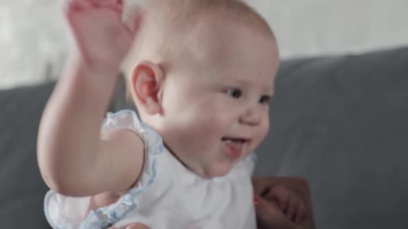 Baby Looking Into Camera and Laughing