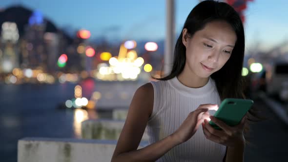 Woman use of mobile phone at night