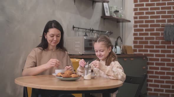 Mother and Daughter Drink Tea