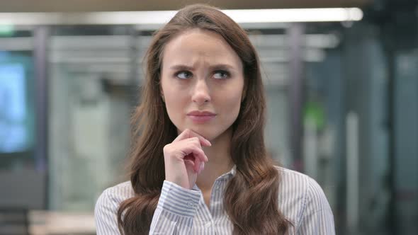 Portrait of Pensive Young Businesswoman Thinking and getting Idea