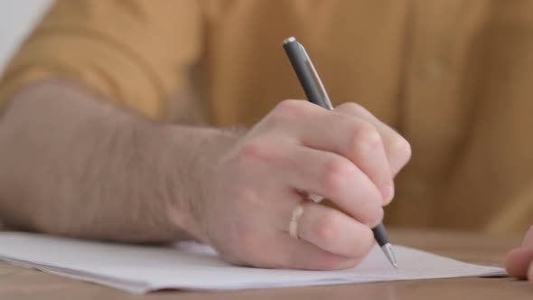 Hands Close up of Young Man Writing on Paper