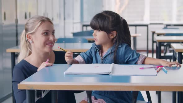 Happy Female School Teacher and Latin Schoolgirl