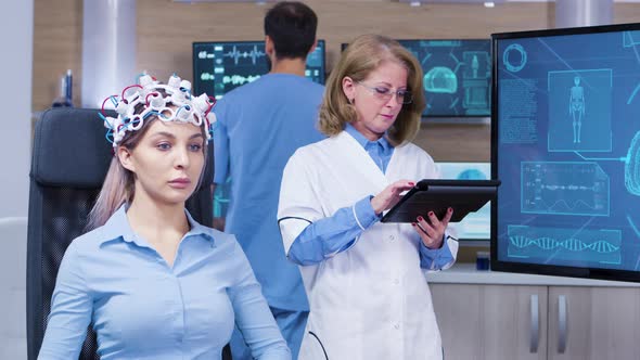 Female Patient with Eyes Closed Wearing Headset with Brain Sensors