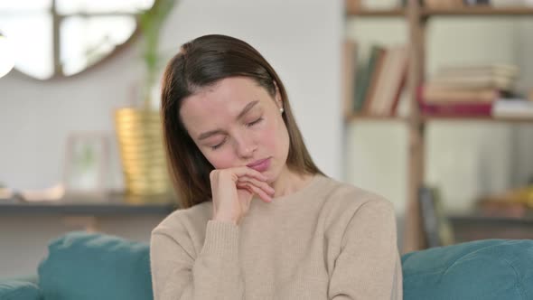 Portrait of Sleepy Young Woman Taking Nap at Home