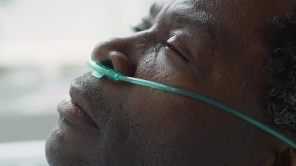 Sick Patient with Nasal Cannula Waking Up in Hospital Ward