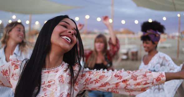 Multiracial friends having fun dancing together outdoor at beach party