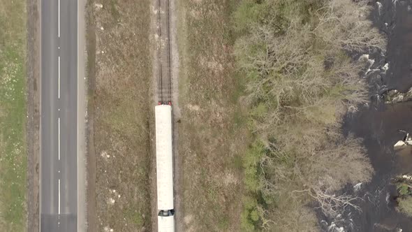 Bird's Eye View of a Train with a Road and River