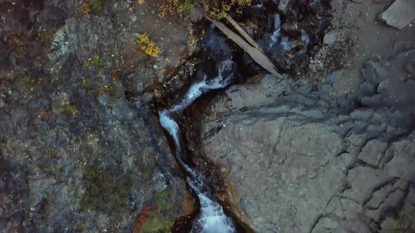 Aerial birds eye view of the waterfall donut falls during a beautiful autumn day with changing leave