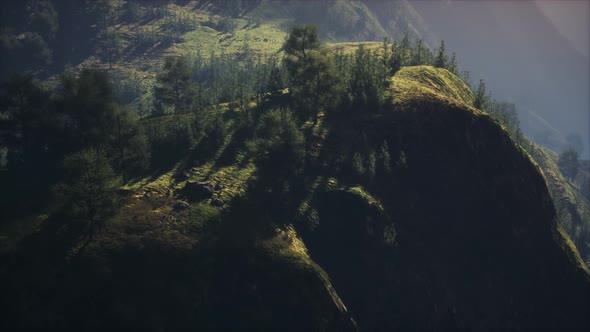 Sunrise in Mountains in a Foggy Morning