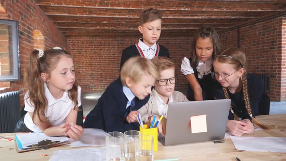 Hardworking Children Using the Laptop.