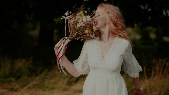 Carefree Boho Woman Walking and Smiling on a Meadow in Summer