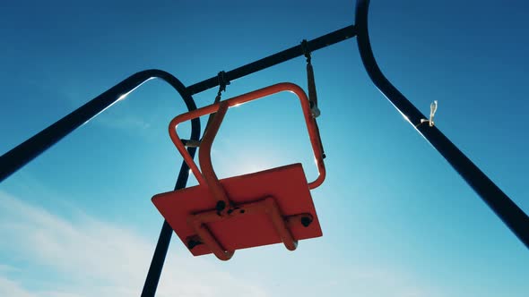 Outdoor Swings in Motion with Nobody on Them