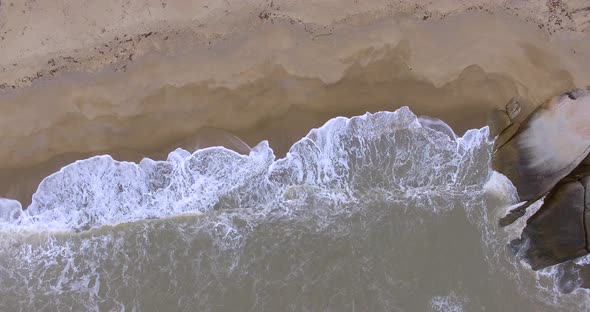 Ocean waves crashing on the stone beach