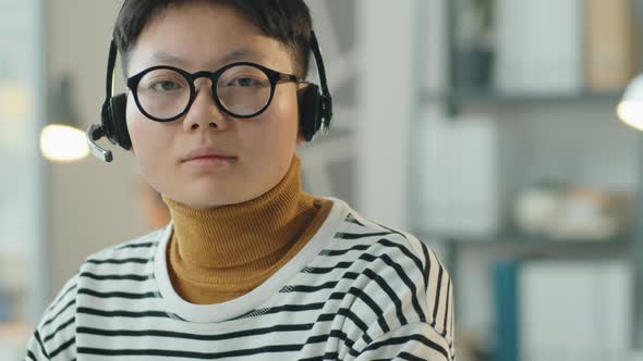 Portrait of Asian Woman at Work in Call Center