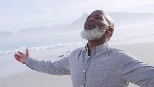 Mature man enjoying time outside by the sea