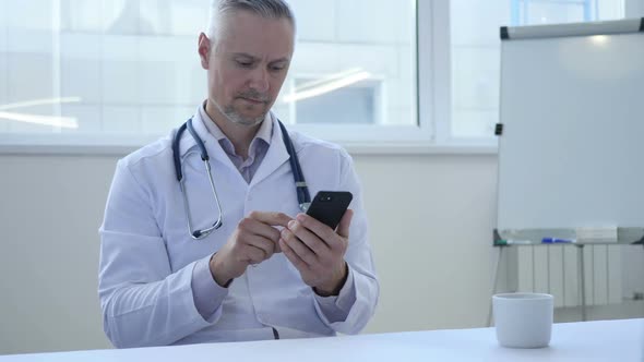 Doctor Using Smartphone in Hospital