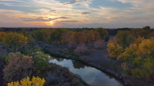 An autumn sunset reflects in mimicked colors a ok game the Platte River in Colorado.