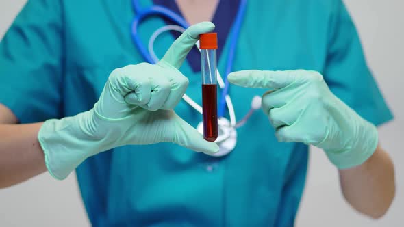 Medical Doctor Nurse Woman Wearing Protective Mask and Latex Gloves - Holding Blood Test Tube