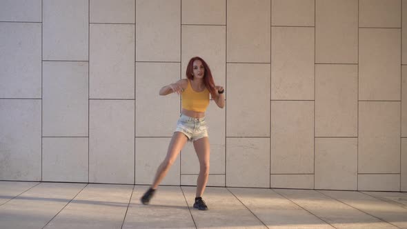 Young Redhead Woman Dancing Hiphop Outdoors