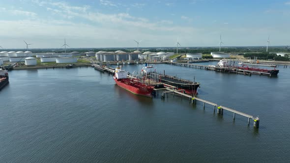 Liquid Cargo Transporter Ships Unloading Crude Oil to a Fuel Depot