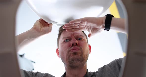 Man Opens Toilet Lid and Looks Thoughtfully