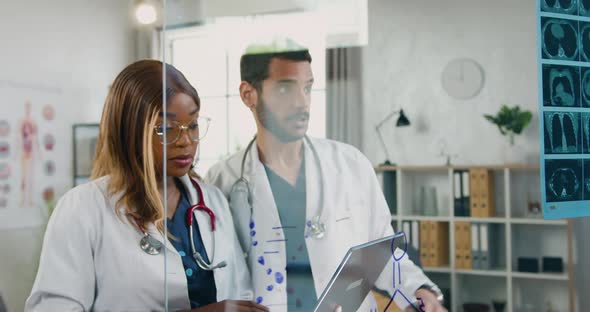 Female Doctor Together with Male Colleague Consulting About right Diagnosis of Patien